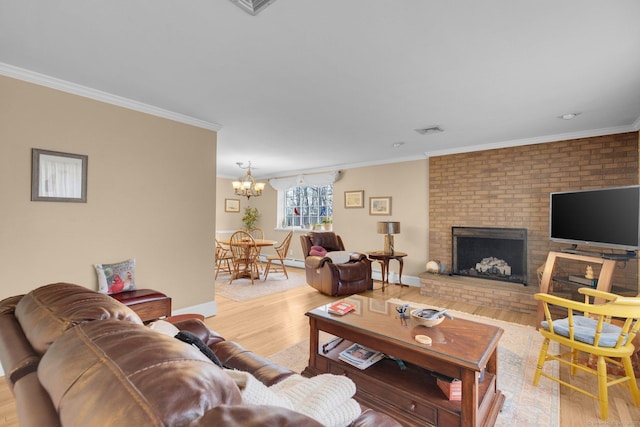 living room featuring visible vents, crown molding, baseboards, a fireplace, and light wood-style floors