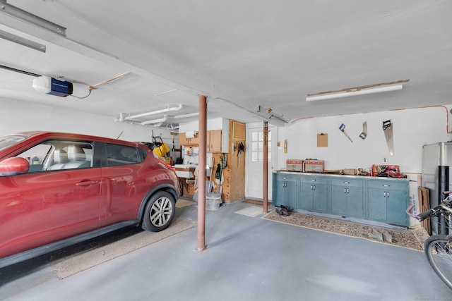 garage with a workshop area and a garage door opener