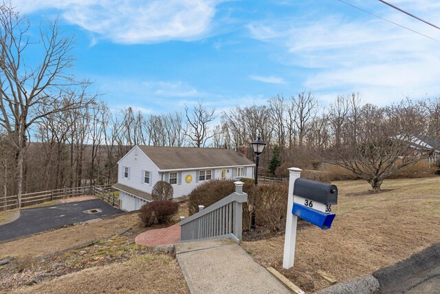 view of front of house featuring a fenced front yard, a garage, and driveway