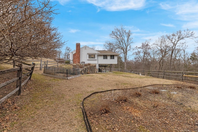 view of yard with a vegetable garden and a fenced backyard