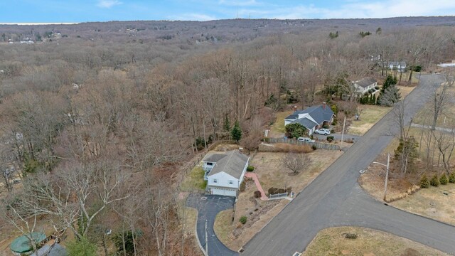 drone / aerial view featuring a wooded view