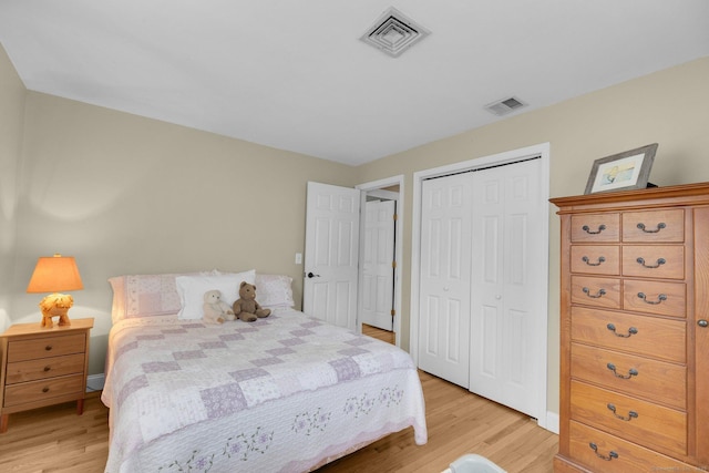 bedroom with visible vents, a closet, and light wood finished floors