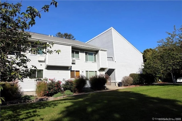 rear view of house with a yard