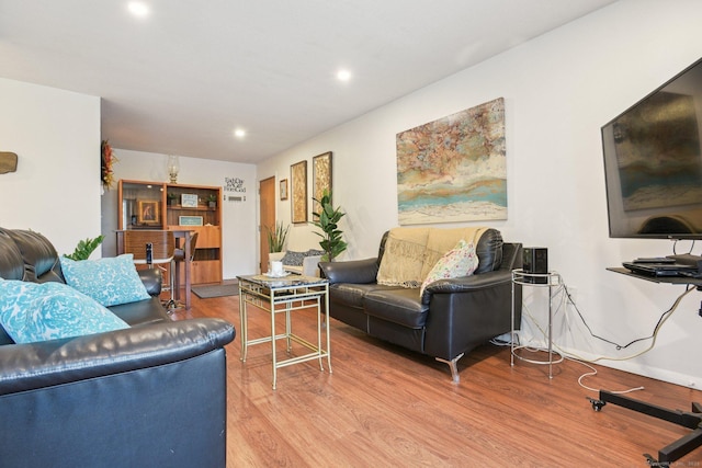 living area with recessed lighting and wood finished floors