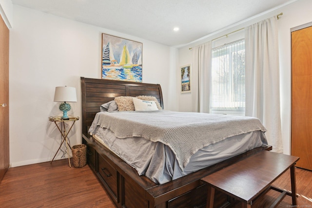 bedroom with recessed lighting, baseboards, and wood finished floors