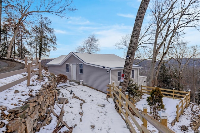 snow covered property featuring fence