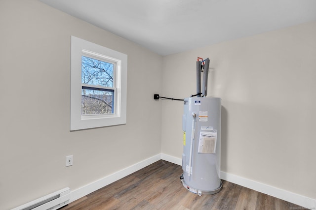 utility room featuring electric water heater and a baseboard radiator