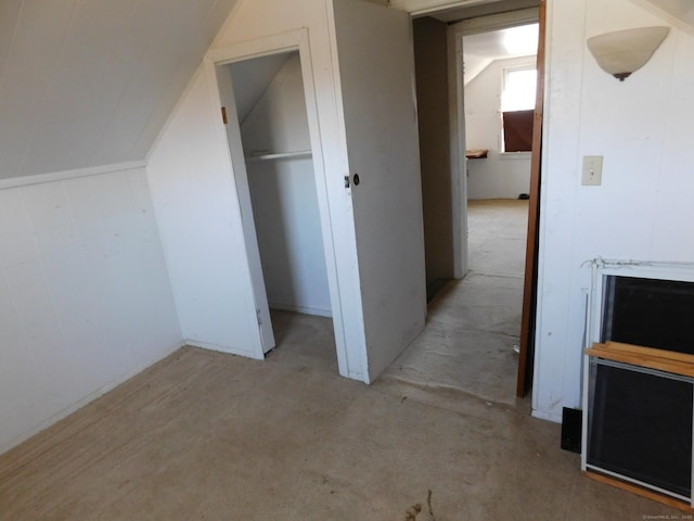 additional living space featuring lofted ceiling