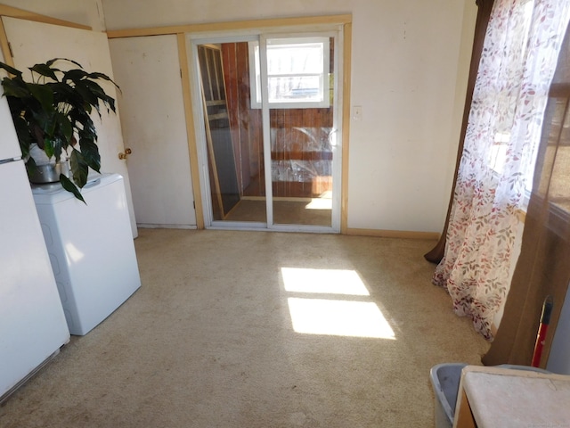 empty room with baseboards and washer / clothes dryer