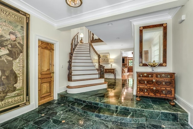 foyer with marble finish floor, stairs, baseboards, and ornamental molding