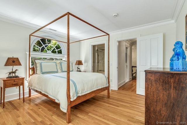 bedroom with baseboards, light wood-style flooring, and crown molding