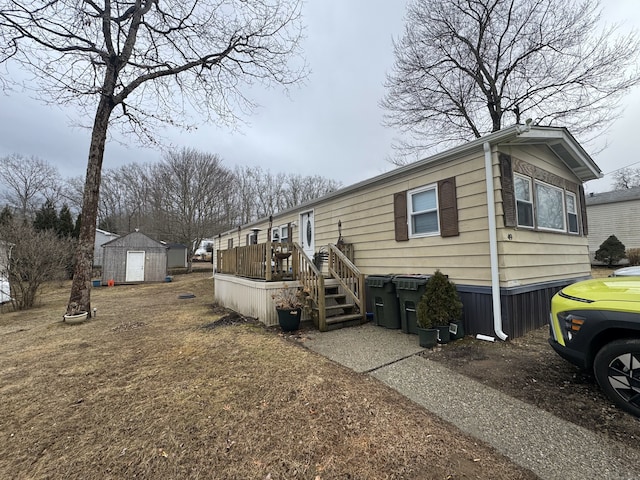 exterior space with a deck, a storage unit, and an outdoor structure