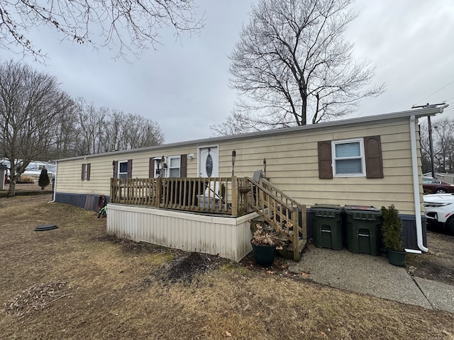 rear view of property featuring a wooden deck