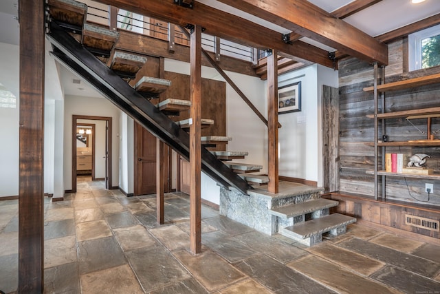 basement with baseboards, stone tile flooring, and stairs