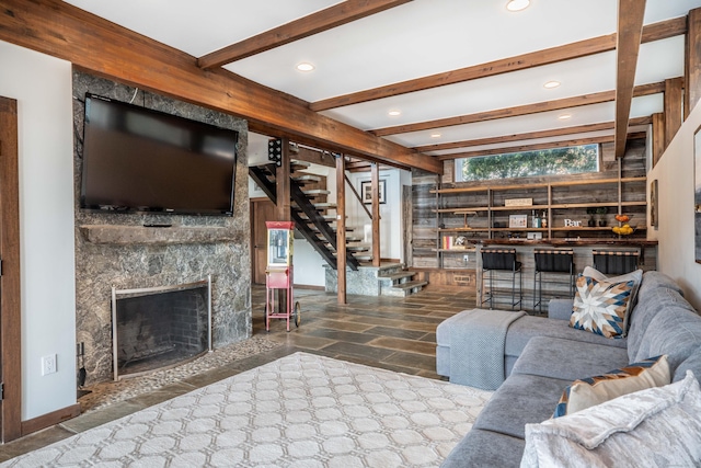 living area featuring stairway, baseboards, a premium fireplace, beam ceiling, and recessed lighting