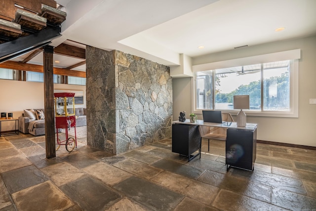 office area with baseboards and stone tile flooring