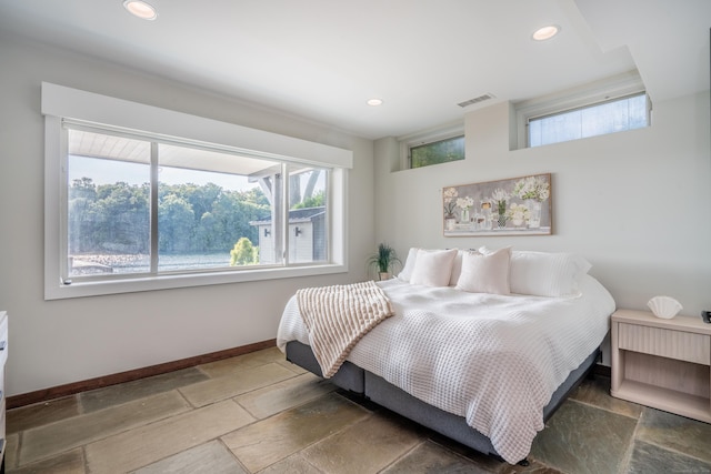 bedroom featuring visible vents, stone tile floors, recessed lighting, and baseboards