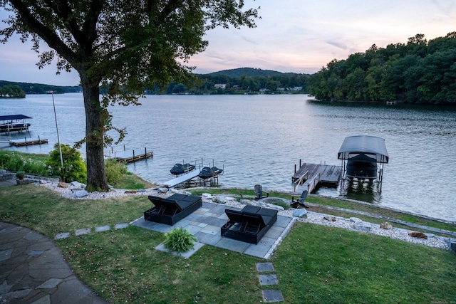 property view of water with boat lift and a dock