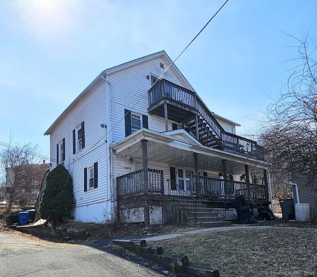 view of front of house with a balcony and covered porch