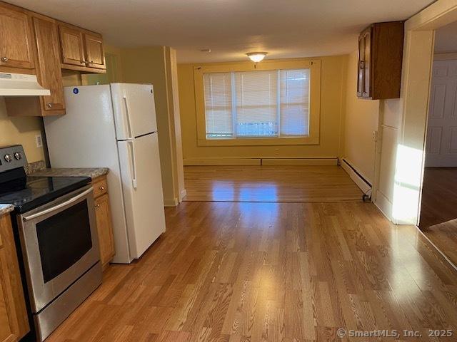 kitchen with a baseboard heating unit, electric stove, brown cabinetry, and under cabinet range hood