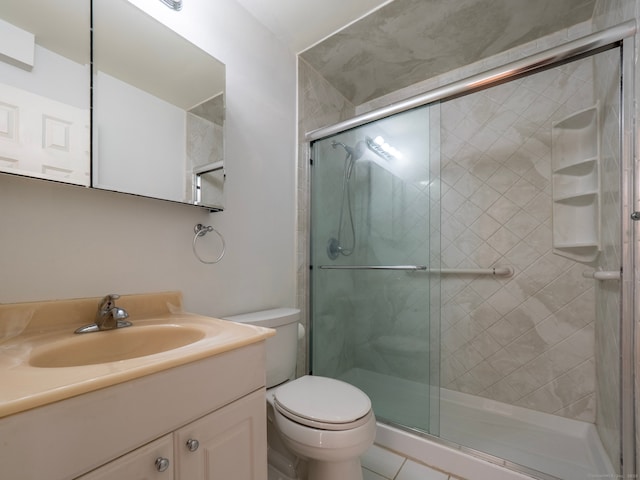 bathroom with vanity, toilet, and a stall shower