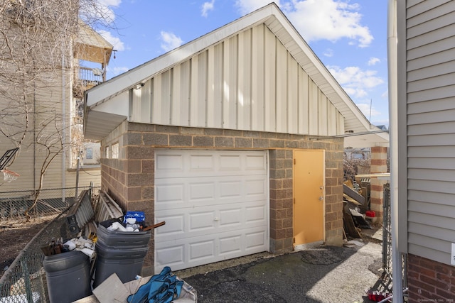 detached garage featuring fence