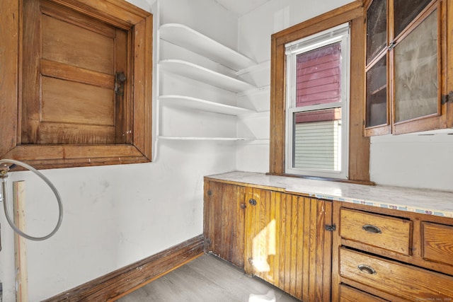 interior space featuring baseboards and wood finished floors