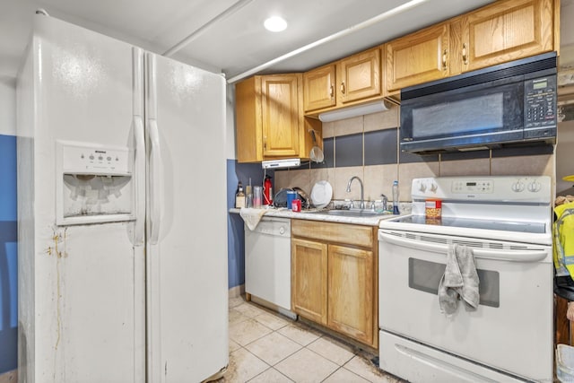 kitchen with white appliances, light tile patterned floors, a sink, light countertops, and backsplash