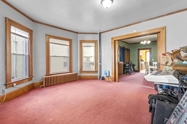 misc room with baseboards, radiator heating unit, ornamental molding, carpet flooring, and a notable chandelier