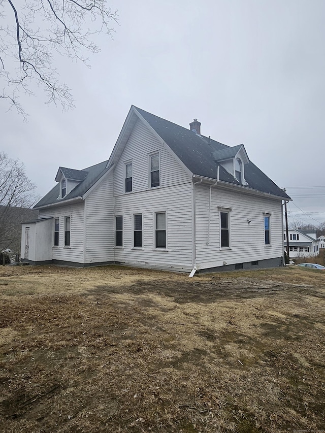 view of side of home featuring a chimney