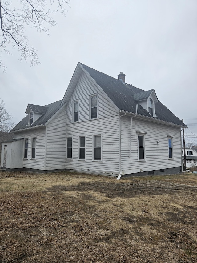 rear view of property with a chimney