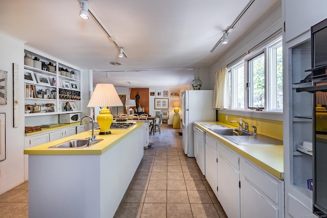 12 Old Forge Hollow Rd, Litchfield, CT 06750 - kitchen with track lighting, an island with sink, white appliances, light countertops, and white cabinetry