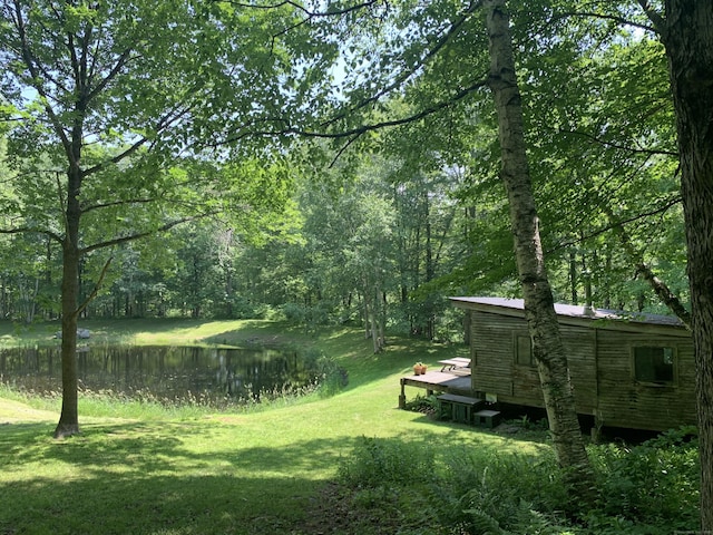 12 Old Forge Hollow Rd, Litchfield, CT 06750 - view of grassy yard featuring a deck with water view and a view of trees