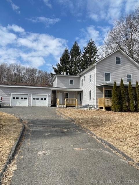 view of front of property featuring aphalt driveway and an attached garage