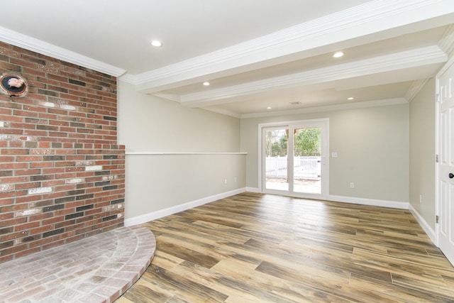 empty room with recessed lighting, wood finished floors, baseboards, and ornamental molding