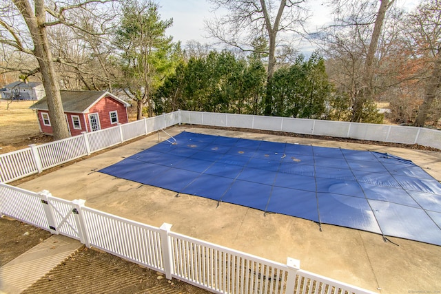 view of swimming pool featuring fence, a fenced in pool, a gate, and a patio