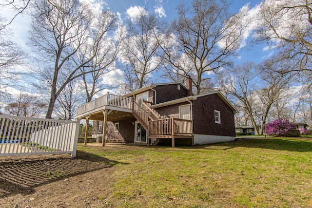 back of property with stairway, a lawn, a chimney, and a deck