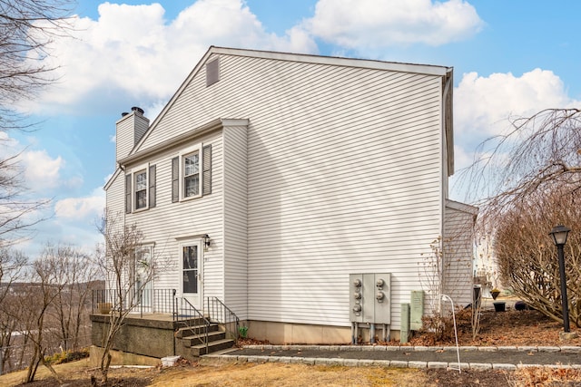 view of front of house featuring a chimney