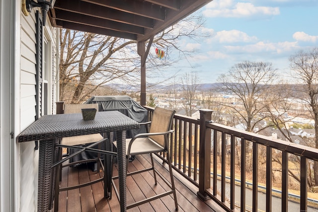 wooden terrace with outdoor dining space