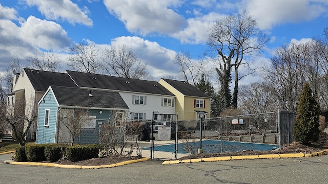 view of sport court featuring a gate and fence