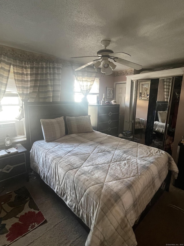 bedroom featuring a textured ceiling and a ceiling fan