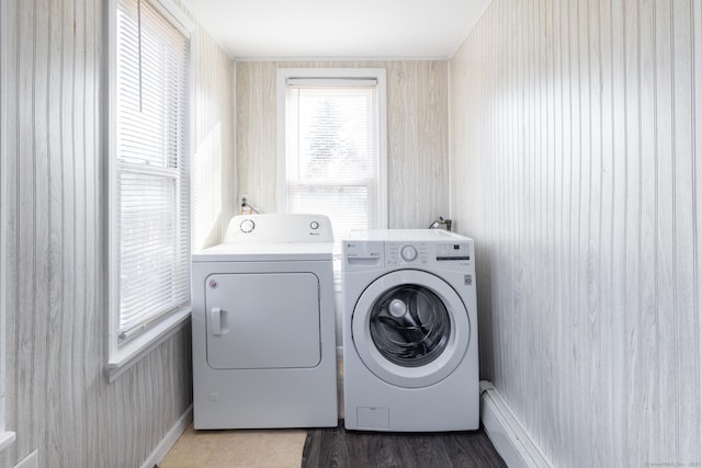 laundry room featuring laundry area, wood finished floors, and washer and clothes dryer