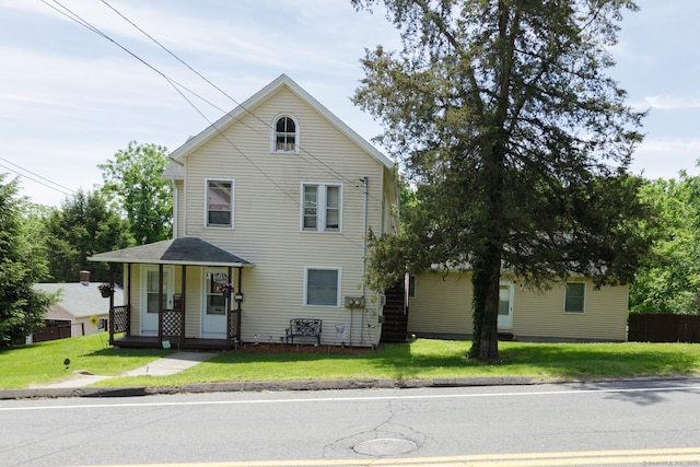 traditional-style house with a front lawn