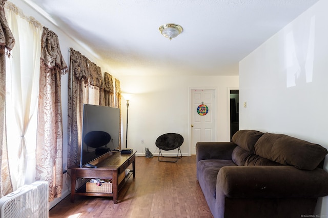 living area with wood finished floors and baseboards