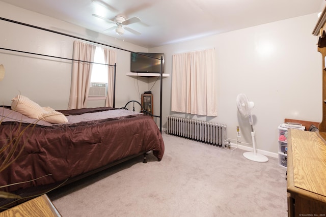 bedroom featuring baseboards, cooling unit, radiator heating unit, ceiling fan, and carpet
