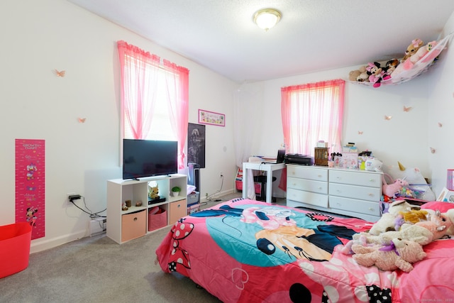 carpeted bedroom with multiple windows and baseboards