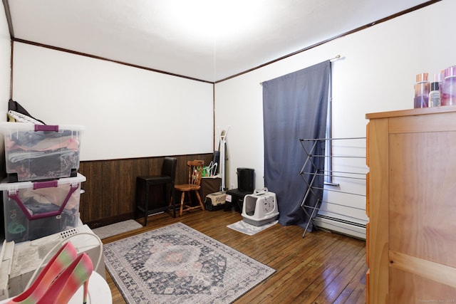 bedroom with wood-type flooring and baseboard heating