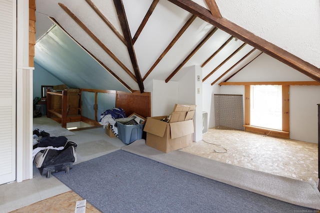 additional living space featuring vaulted ceiling with beams