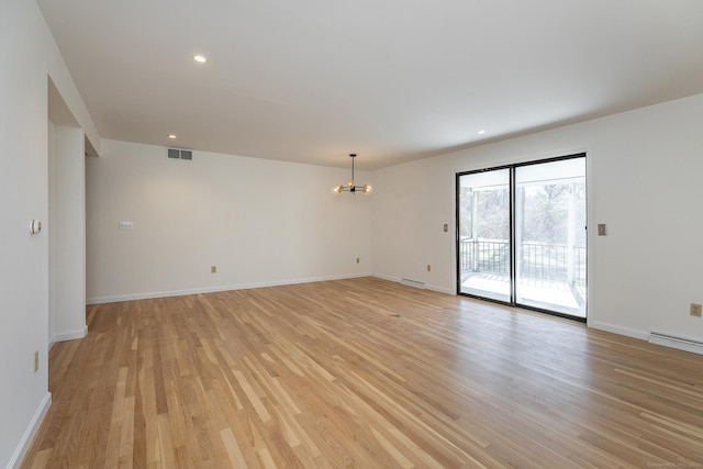 unfurnished room with a chandelier, visible vents, light wood-style flooring, and baseboards