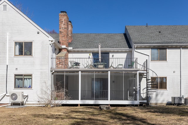 back of house with roof with shingles, ac unit, central AC, a balcony, and a sunroom